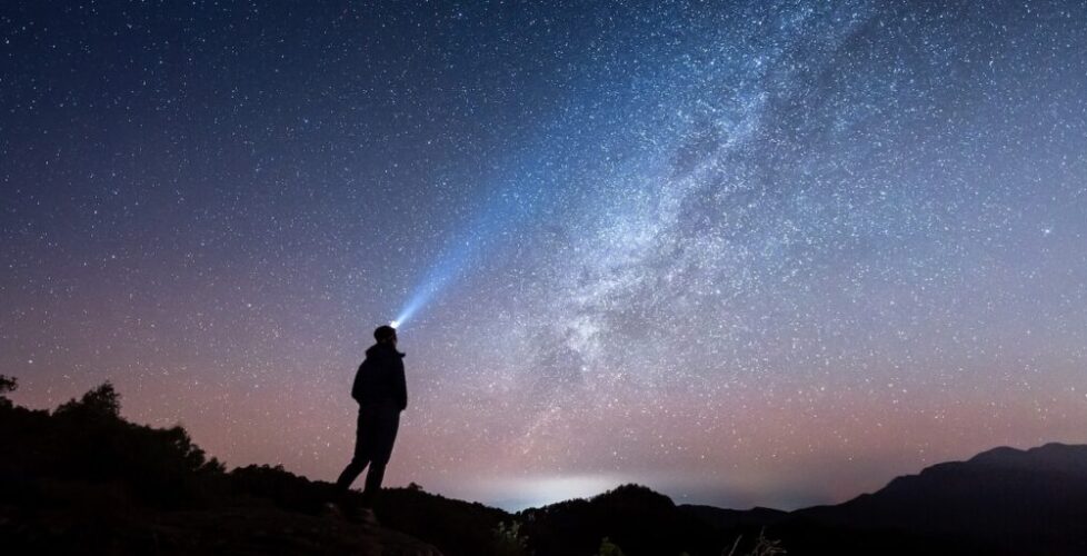 Woman standing under The Milky Way Galaxy